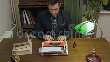 专心致志的作家在柜子里用一台红色老式打字机打新书